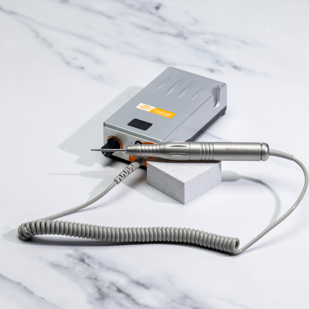 Electric Nail File on marble desk