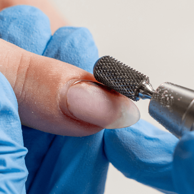 Carbide nail bit removing gel polish on finger nail