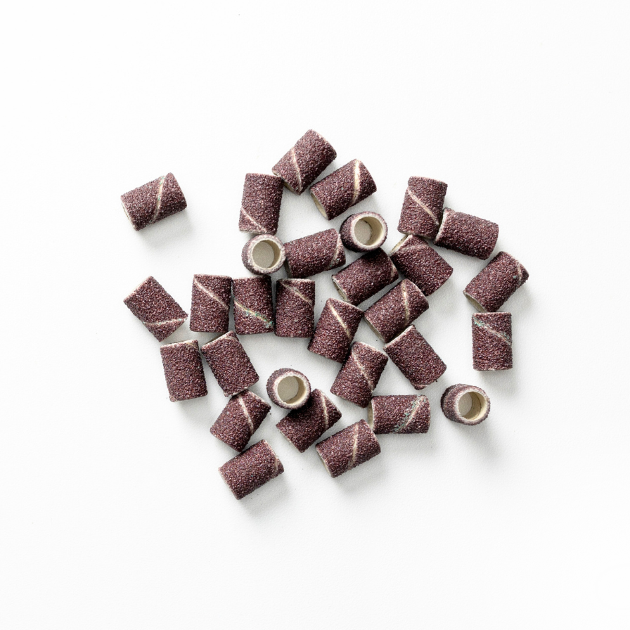 Pile of coarse sanding bands for nails